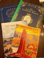 All three printed items stacked showing front covers