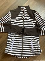 Front view of hoodie laid flat showing overall design and pockets