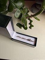 Open green box showing three silver Pandora rings arranged horizontally