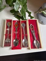 All four flatware pieces in display boxes