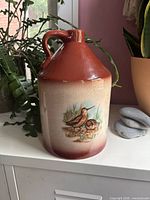 Front view showing bird decal, two-tone glaze and handle