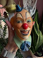 Front view of plaster clown bust showing facial features, colours and size reference