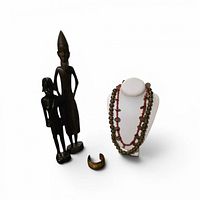 Full lot showing two ebony figurines, cuff bracelet and two necklaces on bust