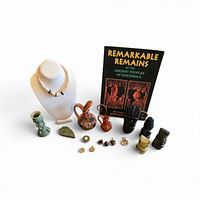 Group shot showing all items: book, necklace, stone carvings, pottery, coins