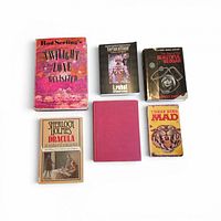 Six books laid out showing front covers