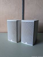 Front view of both Boston CR6 white speakers with grilles attached