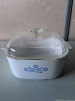 Front view of casserole dish showing Cornflower Blue pattern and glass lid
