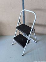 Front view of folded-out 2-step stool