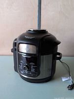 Front three-quarter view of Ninja TenderCrisp cooker showing body and attached lid