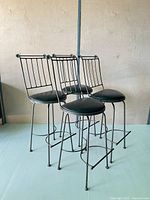 All four matching metal bar stools