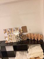 All items together on shelf: wood peg rack, iron rack, cardboard boxes