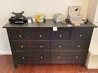 Front view of black dresser with all drawers closed