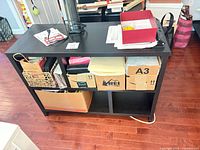 Front view of console table showing four cubbies and top surface