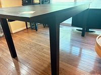 Full view of dining table showing legs and rectangular shape