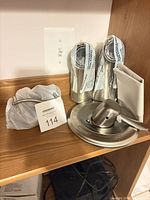 Entire set on shelf: valve sleeves, tub spout in bag, escutcheon plate with lever handle
