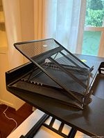 Close view of detachable mesh tilt laptop stand on desk converter
