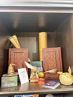 Shelf view showing Sorting Hat, Golden Snitch, faux book boxes, scrolls