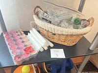 Full lot showing wicker basket, sealed TINDRA tealights, taper candles
