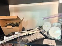 Overall lot with LED strips, puck lights in bag, string lights in box, manual and adapter