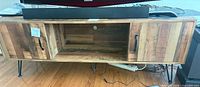 Front view showing entire TV stand, doors, open shelf, hairpin legs