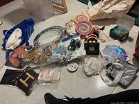 Mixed lot laid out showing wreath frames, lollipop ornaments, nutcracker figure, Hallmark box, ribbons, bags of craft pieces