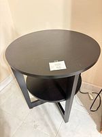 Full view of round black veneer end table