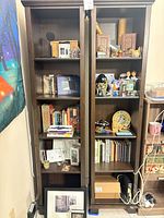 Front view of both bookcases filled with assorted items
