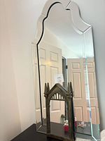 Large frameless arched mirror with small Mirror of Erised in front