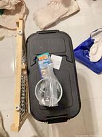 Top view of bin, pet gate, bowl, hardware bag, Lixit package