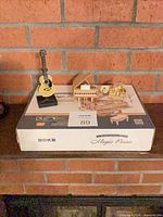 All three figurines on top of ROKR Magic Piano box