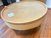 Overall view of side table showing round swing-tray top and tripod legs