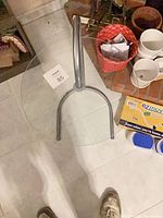 Angled view showing complete table, glass top, and metal base