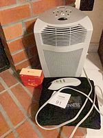 Space heater front view with remote, pouch and box