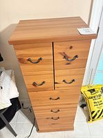 Front view of tall pine dresser with seven drawers