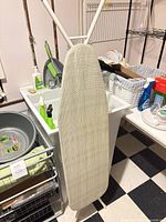 Ironing board upright, front cover visible