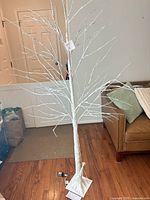 Full view of white LED birch tree standing on floor