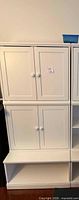 Front view of stacked white MDF cabinet and shelves
