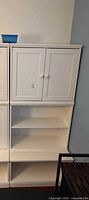 Front view of stacked white modular bookcase units