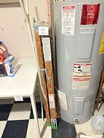 Ladder folded against water heater showing full height and labels