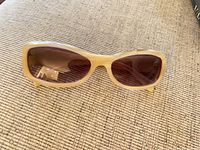 Front view of cream Chanel sunglasses