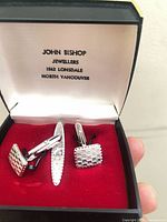 Open presentation box showing pair of cufflinks and tie clip with John Bishop branding