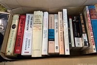 Box containing row of standing books showing most titles and spines