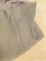Folded black strapless dress showing zipper closing