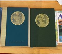 Reader's Digest atlas book and matching slipcase showing gilt medallion