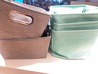 Gray and mint green bins side by side