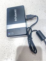 Top view of Polaroid ZINK printer showing logo and silver band