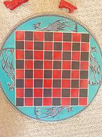 Top view of circular board showing giraffe motif and grid
