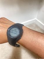 Watch worn on wrist showing overall appearance and digital display