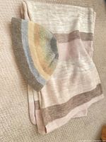 Beret and scarf laid out together showing colours and patterns