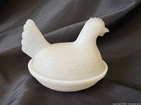 Front view of milk glass hen on nest covered dish